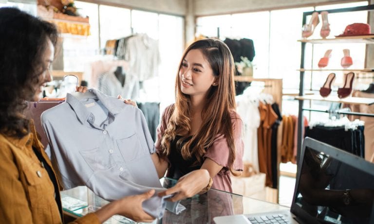 Woman returning piece of clothing to retailer