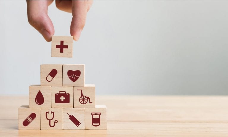 Wooden block pyramid with healthcare icons on each block