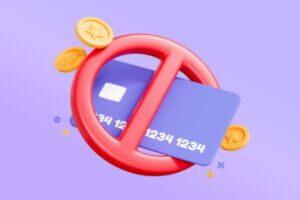 3D bank credit card with a block symbol and coins representing closing a credit card with a balance.