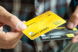 Man holding two credit cards